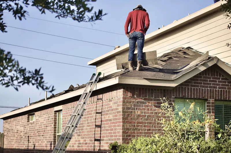 Professional roofer working on a residential roof in Roebuck